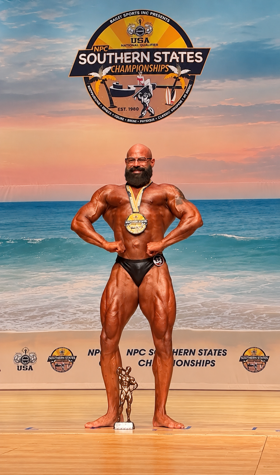Frank The Tank on the Southern States Championships stage with his medal and trophy